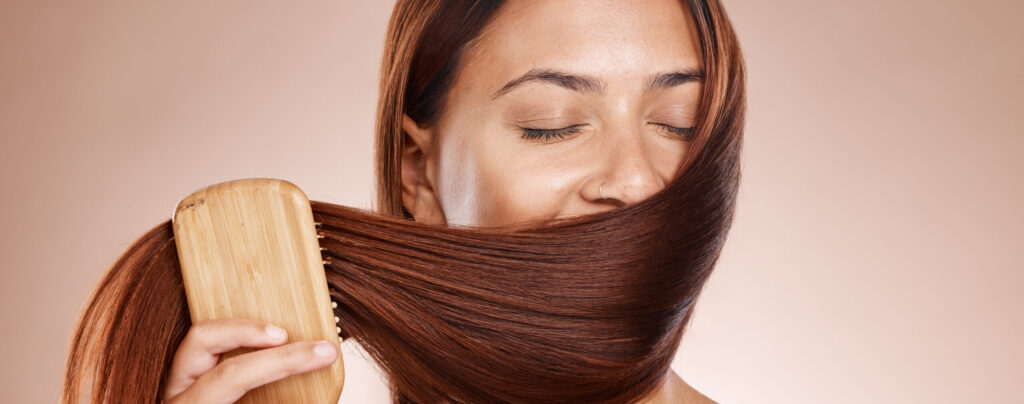Hair care, beauty and brush of a woman brushing after a salon, hairdresser or shampoo treatment in .